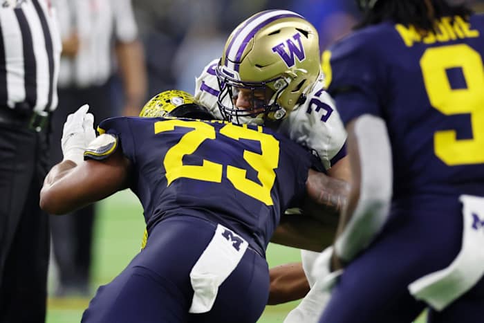 Jan 8, 2024; Houston, TX, USA; Michigan Wolverines linebacker Michael Barrett (23) tackles Washington Huskies tight end Jack Westover (37) during the second quarter in the 2024 College Football Playoff national championship game at NRG Stadium. Mandatory Credit: Thomas Shea-USA TODAY Sports  